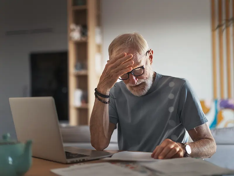 concerned man on laptop
