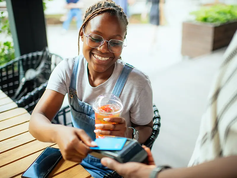 woman paying for lunch with a debit card
